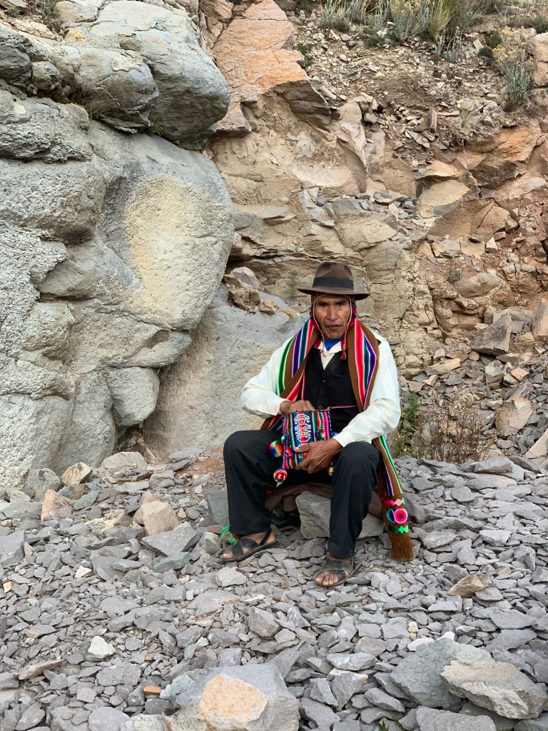 A person riding on top of a rock
Description automatically generated